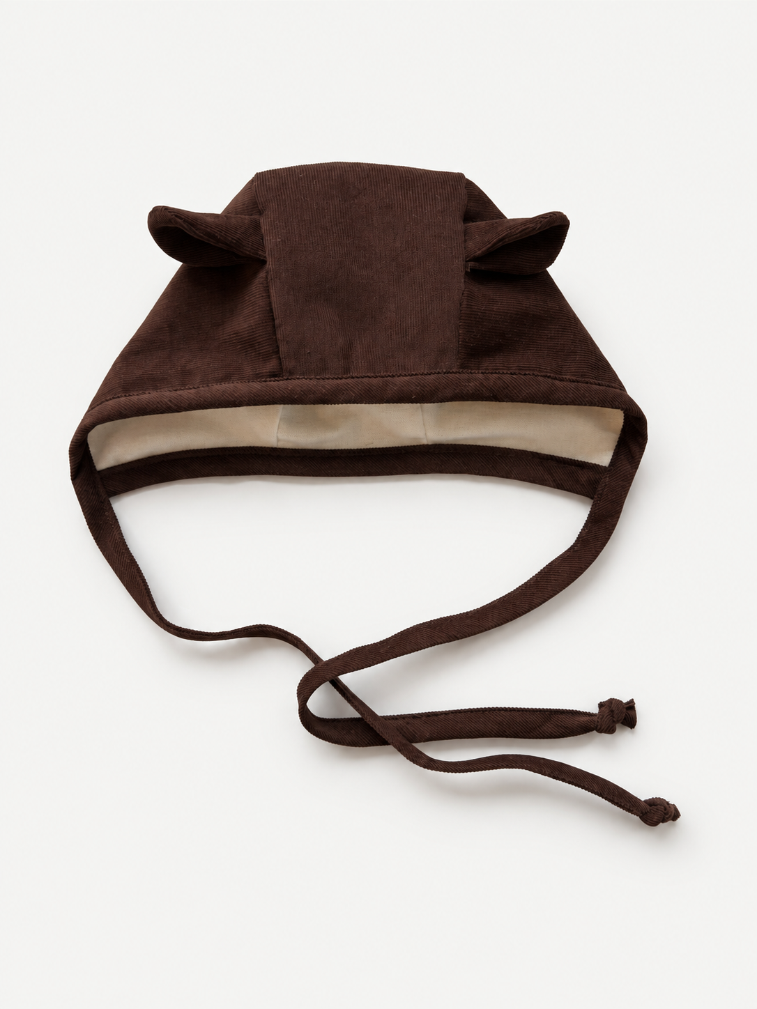 A dark brown plush animal hat with long ties and ear-like flaps, shown on a clean white background.