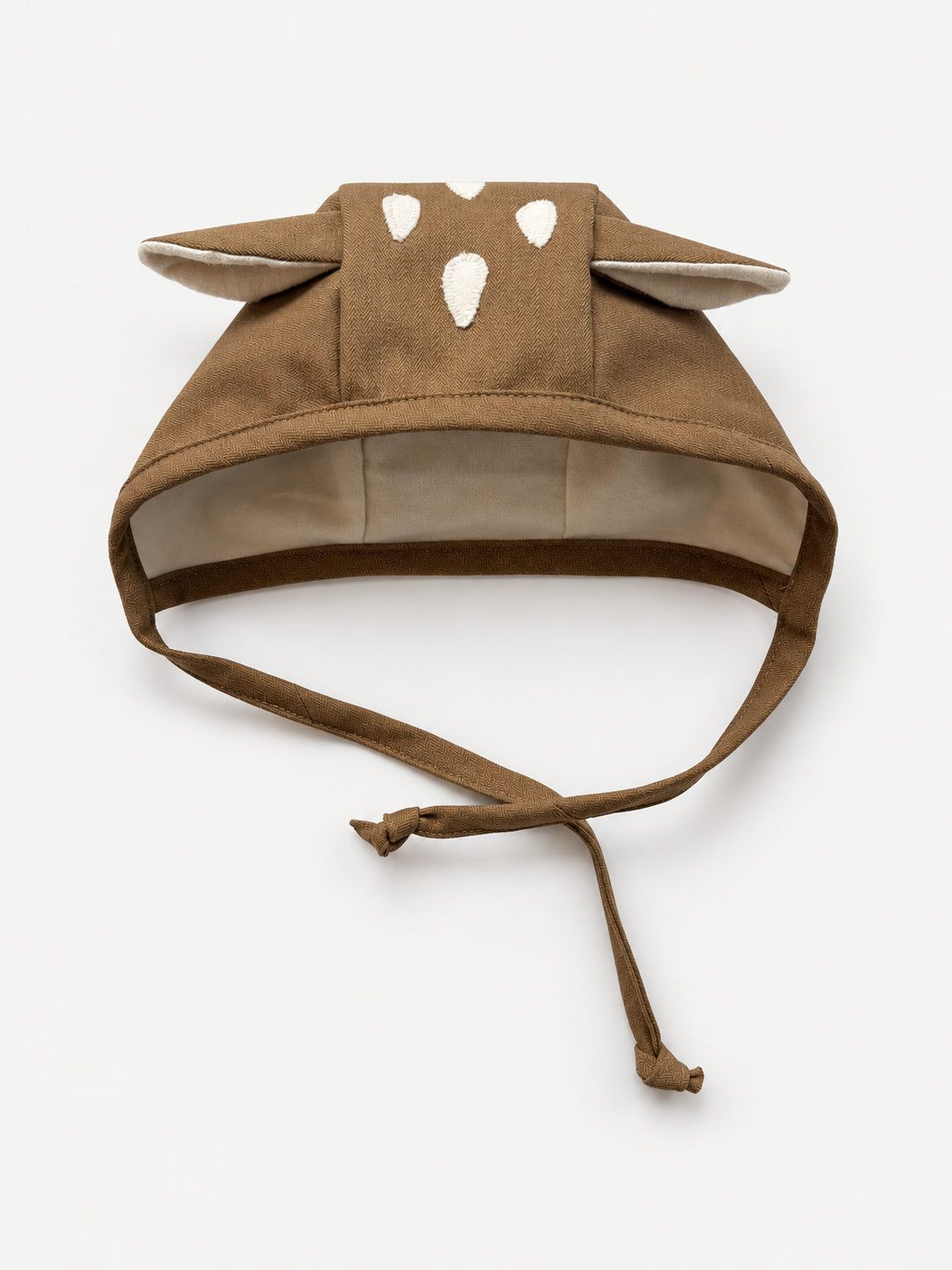 A brown fabric baby fawn bonnet with long ear, and adjustable tie straps, shown on a plain light background.