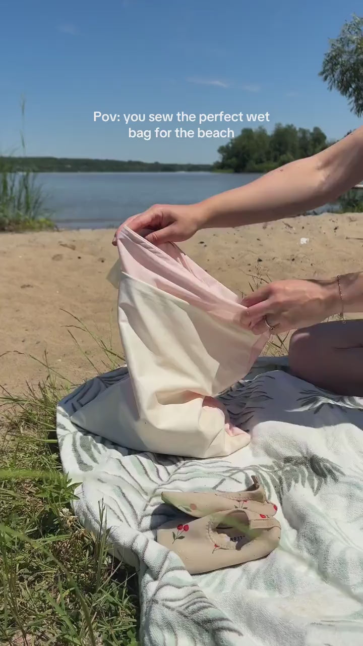 A girl placing water shoes into a waterproof bag and closing it with a zipper. Text reads: “POV: You sew the perfect wet bag for the beach.”