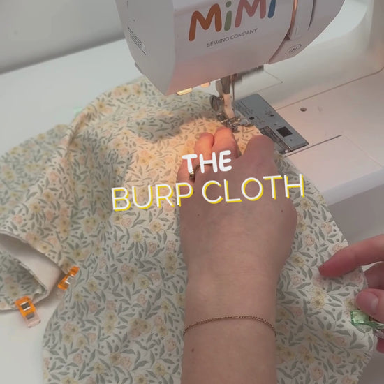 Video showing a girl sewing a burp cloth. Text on screen reads: “Sewing a burp cloth.”