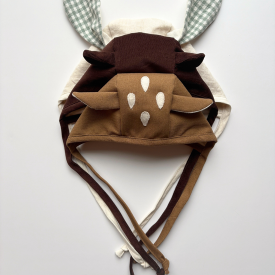 video showing the pattern and the final results of 3 differents animal bonnet : bunny, bear and fawn. On a light grey background for Mimi sewing company